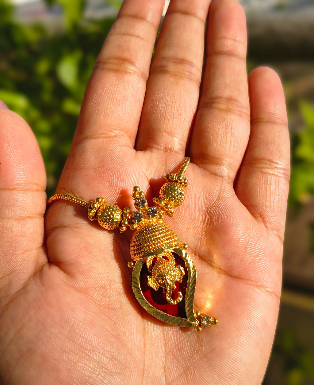 Traditional Handpicked Simple and elegance Ganesh pendant necklace with premium gold finish and royal detailing Jewellery.