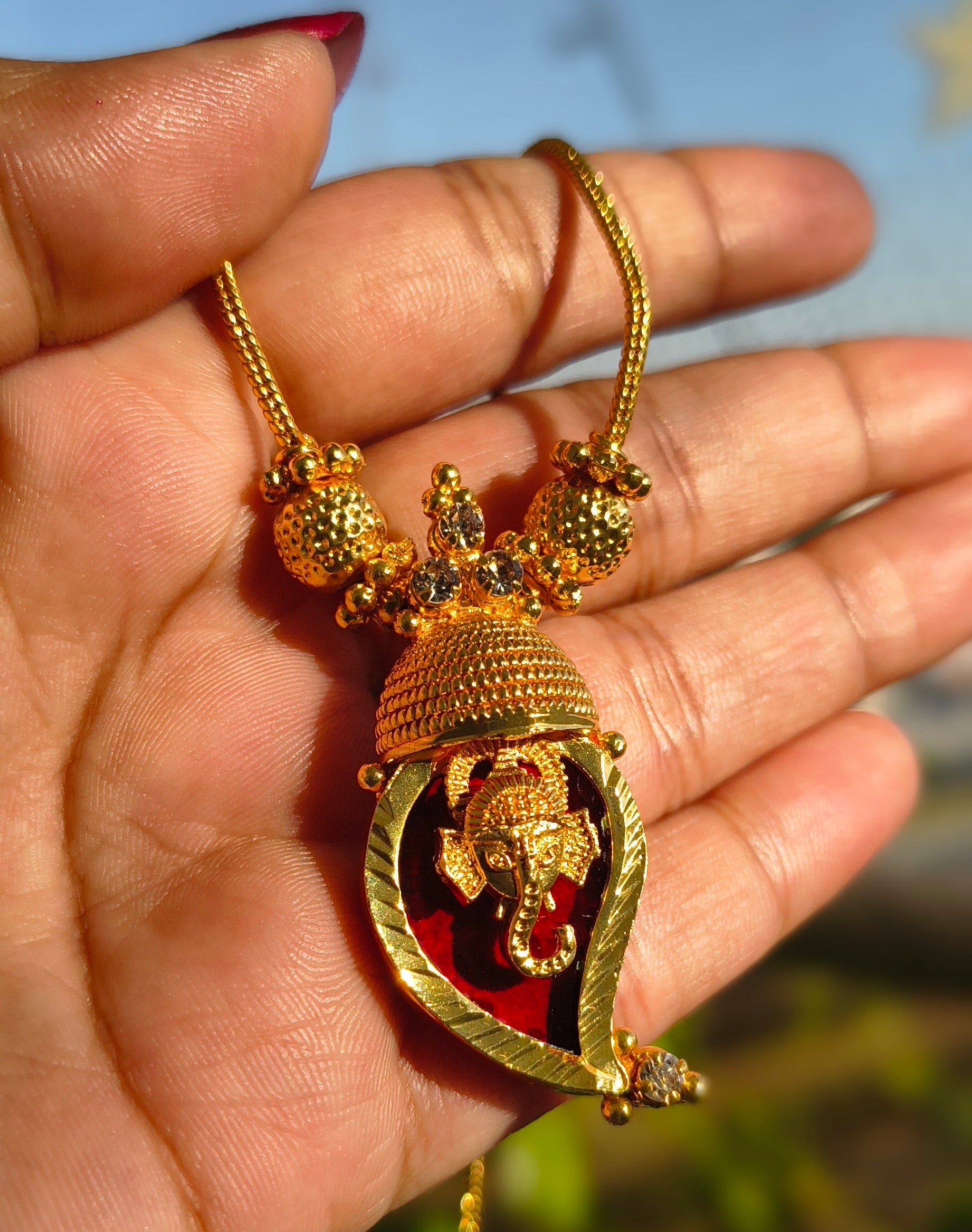 Traditional Handpicked Simple and elegance Ganesh pendant necklace with premium gold finish and royal detailing Jewellery.